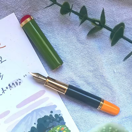 A cheap fountain pen that's clearly a knock-off of the other pen. Not very well color matched, but... 