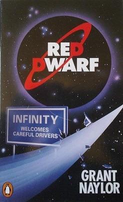 Book cover with Red Dwarf logo in a vague planetary circle above a free way style sign which reads “Infinity welcomes careful drivers”.  One corner of the sign appears broken with pieces floating off from what looks to be a vapor trail from supposedly an unseen space ship.  The authors name is in the lower right Grant Naylor.