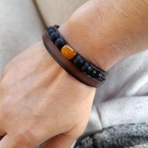 Wrist wearing a beaded leather bracelet