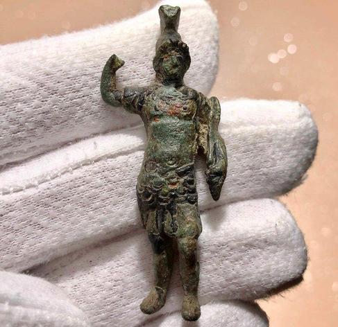 Ancient Roman bronze statuette of Mars, the god of warfare, with a nice olive green patina. He is in full armour with a crested helmet and used to carry a spear in his right.