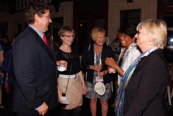 Socials at conferences: photograph of five people chatting at a conference reception. Photo attribution: Flickr user IFLA 2011 Goethe-Institut Reception