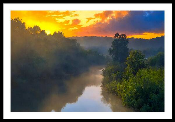 Sunrise over a river covered in fog