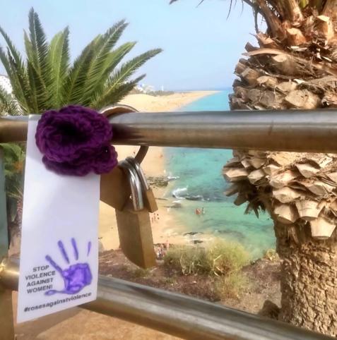 a knitted purple rose in fuertaventura, spain. stop violence against women