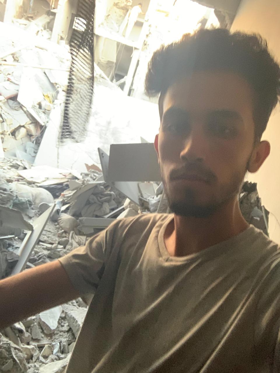 Mohammed Shobair, 22 years old, from Gaza, standing in the ruins of our old flat.