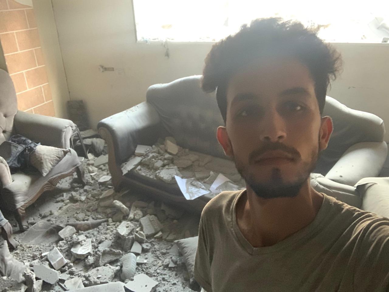 Mohammed Shobair, 22 years old, from Gaza, standing in the ruins of our old flat.