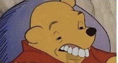 1960s Disney Pooh Bear sitting in chair and pulling the stupidest face a honey loving little bear can pull. His teeth are all goofy, his eyes askew like he's been drinking, it's hilarious! 