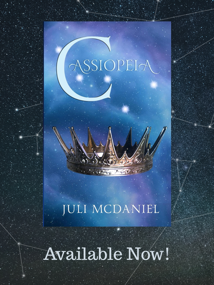 A background of various constellations in the night sky with the image of a book cover. The cover says Cassiopeia across the top with a gold crown below. Written by Juli McDaniel.