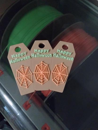 pictured is three Halloween Toppers for a 40oz Stanley Cup.
On the left is the 2nd version, it worked much better then the 1st version - but had a couple of small problems, mostly the spider web and text extend to the base of the coffin - which isn't what I was trying to do.
The 3rd version the middle and right coffins, fix those problems - The spider web and text are both raised just slightly higher.
To get this version to print correctly I started off with the model being orange in color and filled the coffin with brown using the Orca slicer, I had to change the color of the text as well which was a bit of a pain, but not too bad using the tools in the slicer. This keep everything in place and on the level it needed to be.
The coffin is brown (or brownish) in color, the web is orange and the text is a glow in the dark green. 
The 3D printer used is the Anycubic Kobra 3 combo