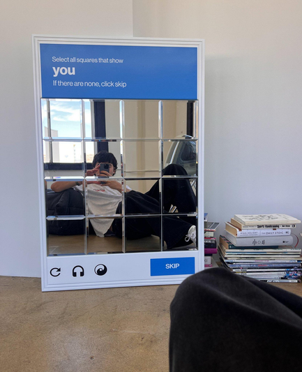 A young person taking a selfie in a mirror resembling a captcha challenge. The prompt asks:

Select all squares that show
you
If there are none, click skip