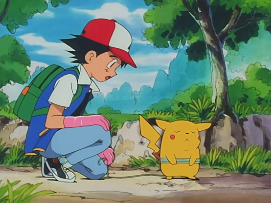 Ash Ketchum, wearing his iconic red and white cap, white T-shirt, blue vest, and jeans, is crouched down beside Pikachu on a forest path. He is wearing bright pink rubber gloves and looking at Pikachu with a concerned and slightly pleading expression. Pikachu, standing to Ash’s right, has its eyes tightly shut, cheeks puffed out, and ears angled downward, expressing clear defiance or frustration. Pikachu’s tiny arms are crossed over a blue-and-white strap, possibly part of a belt or harness. The setting is a lush, sunlit outdoor area with rocky terrain, green shrubs, tall grass, and large trees, all set under a partly cloudy sky with soft blue mountains in the distance. The scene captures the early tension in their relationship, just after Ash receives Pikachu but before they begin to trust each other, conveying a mix of humour, stubbornness, and the early seeds of an eventual bond.