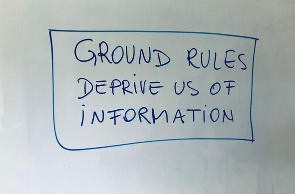 A whiteboard with the words "Ground rules deprive us of information" written inside a rectangle.