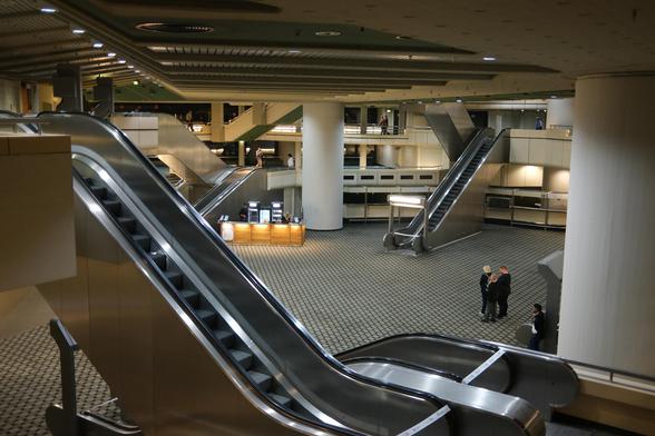 Elevator and brutalist hall.