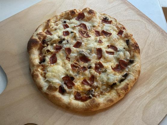 A pizza after coming out of the oven