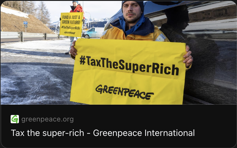 Two Greenpeace activists block the street with banners reading: "#TaxTheSuperRich - Greenpeace" and "Fund a just and green future! #TaxTheSuperRich - Greenpeace"