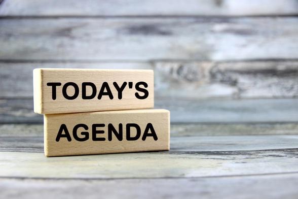 The words 'Today's agenda' written on wooden blocks sitting on a wooden bench. Image by Parichatphoto via Shutterstock.
