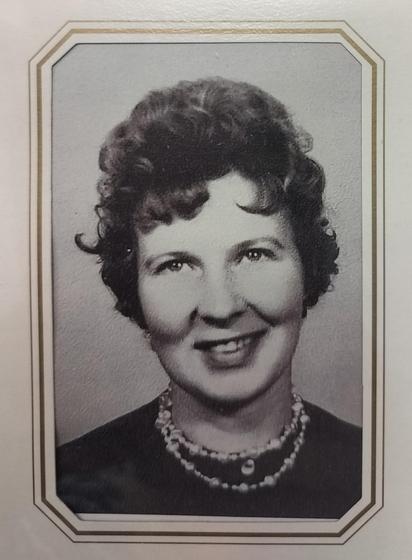 A b&w photo of my mother when she was 16. She looks much older - maybe because the style was different then. She has dark short hair and curls. 
