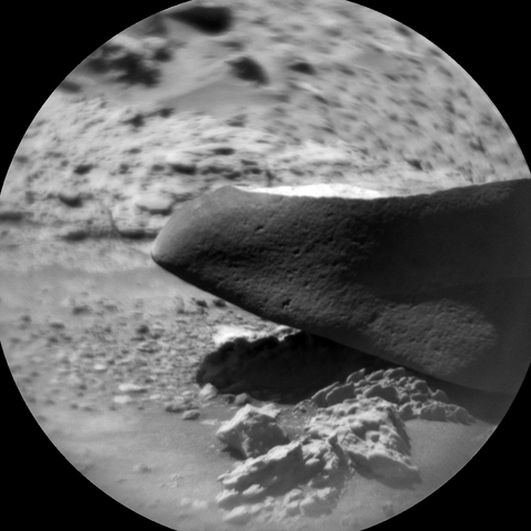 A black and white photography of a Martian rock captured by the rover Curiosity with its RMI telescope.