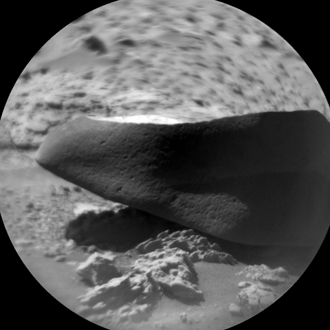 A black and white photography of a Martian rock captured by the rover Curiosity with its RMI telescope.