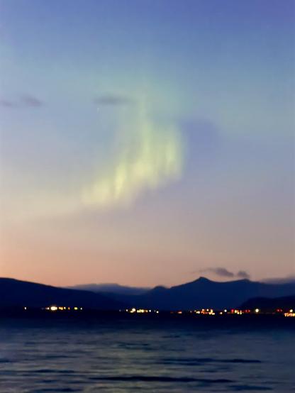 A curving bit of aurora can be seen with a pinkish-hued sky