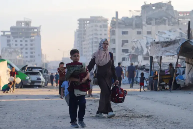 A young woman & a boy flee Gaza City just with a bag.