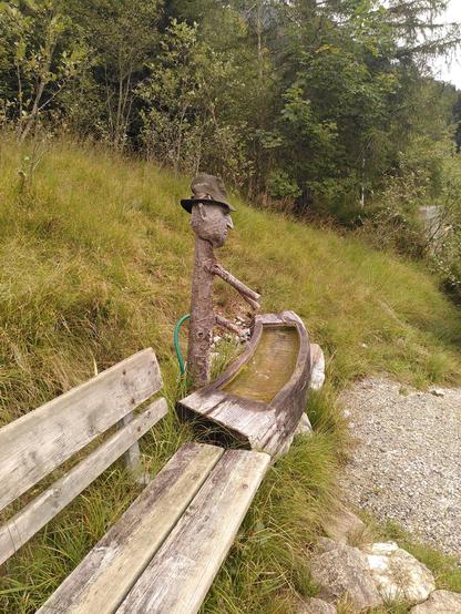 Photograph of a water pump in the shape of a man. The water comes out of his willy. The same concept as a famous Roman fountain uses with a sculpture of Priapus.