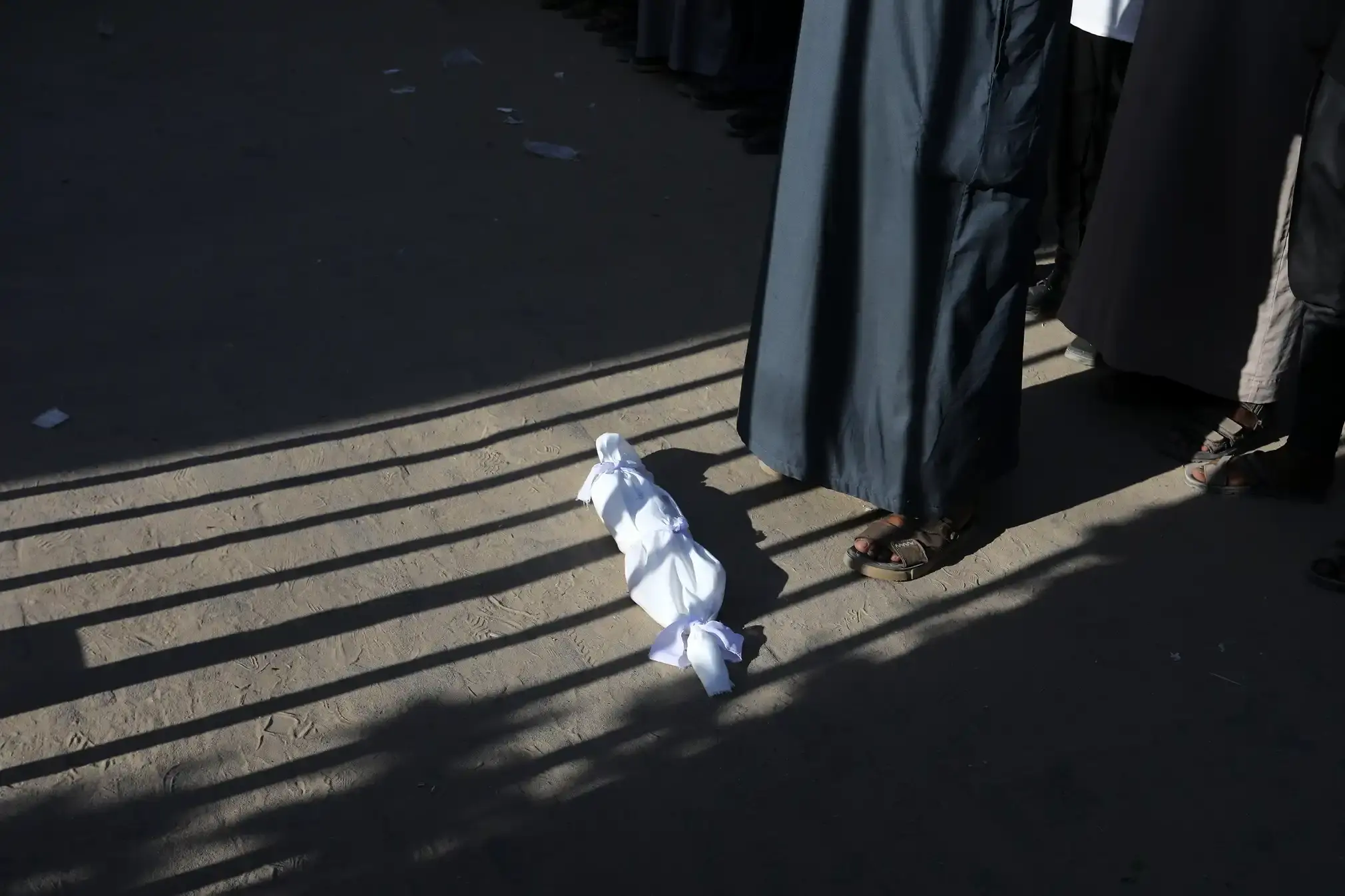 The body of one-month-old Majed Mohammed Zarab who is believed to have died from malnutrition, is brought to Nasser hospital for his funeral.