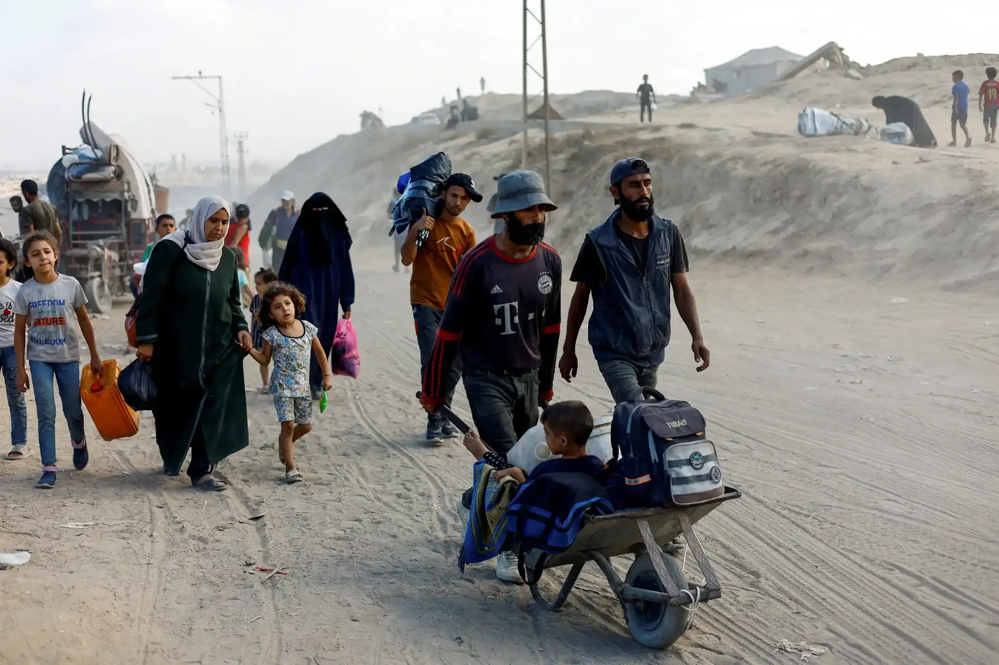 Palestinians flee northern Gaza, some on foot, some in a wheelbarrow.