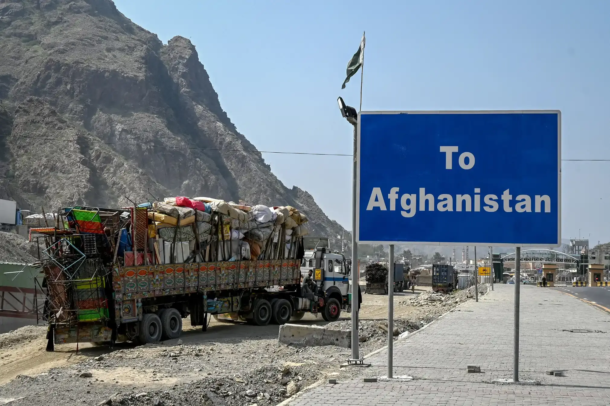 Afghan refugees wait for deportation as they arrive in their trucks at the Pakistan-Afghanistan border, Torkham