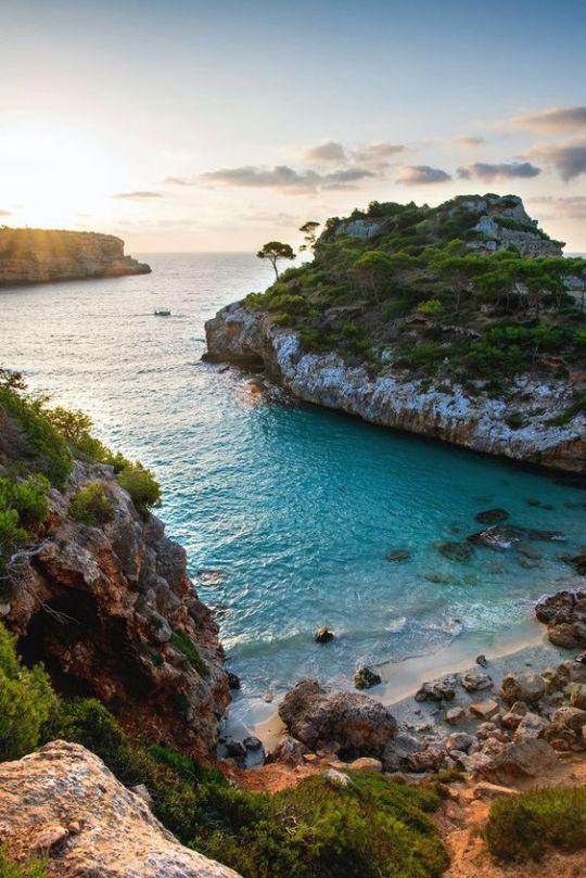 An aerial view of a seaside cliff and an island or promontory.