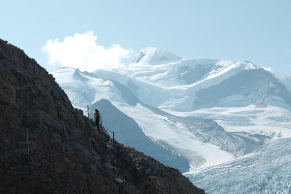An image of my partner ascending a ledge, high above a glacial valley. The glacier and mountain we are hiking beside can be seen in the background. An absolutely incredible place and moment to exist in.