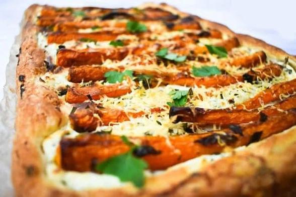 Close up of carrot puff pastry tart with a blonde base.