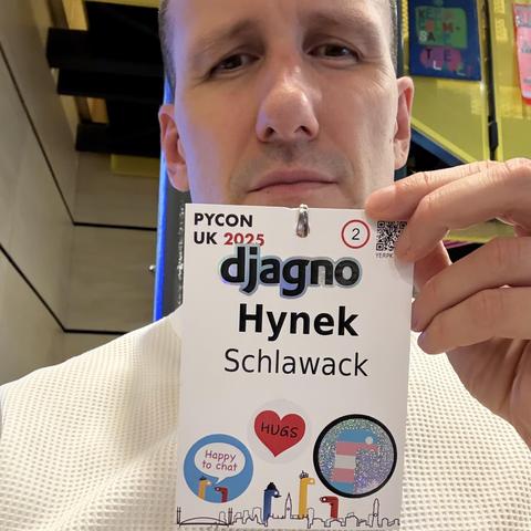 PyCon UK badge with a “djagno” sticker that I haven’t made I swear