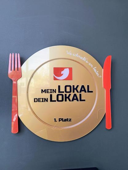 Zu sehen ist der Gewinnerteller der Kabel1 Sendung "mein Lokal dein Lokal", der im Dockside Restaurant aufgehängt ist.