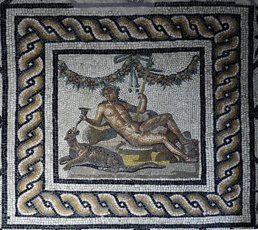 Roman mosaic of Dionysos reclining and feeding his pet panther wine from a rhyton, a horn-shaped drinking cup. A garland of plants and flowers hangs above them and the god holds his iconic thyrsos in his left, a staff with a pine cone at the tip.