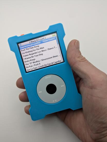 A blue 3d printed shell for a ipod that has flared corners held in a hand