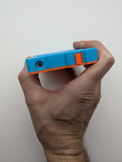 The top of the 3d printed ipod shell showing a recessed headphone jack and a redesigned lock switch