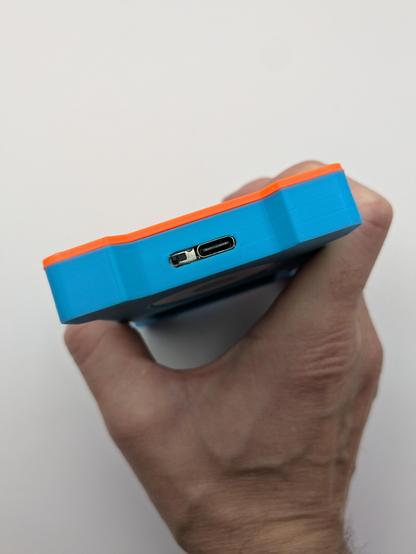 Showing the bottom of the 3d printed shell showing the usb c port and the switch for the Bluetooth 