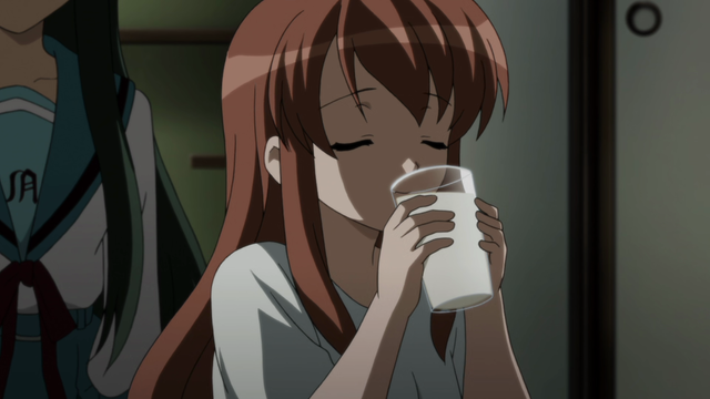 A girl (Mikuru) drinking out of a class which is actually spiked with sake.