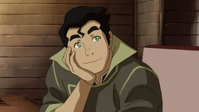 Animated character Bolin from The Legend of Korra rests his chin on his hand, smiling softly. He has green eyes, thick black eyebrows, and a confident expression. He’s seated indoors, wearing an olive green outfit with a high collar.
