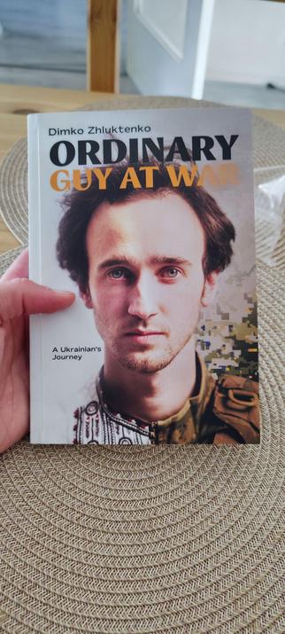 The cover of "Ordinary Guy at War" by Dimko Zhluktenko, featuring a close-up portrait of the author.