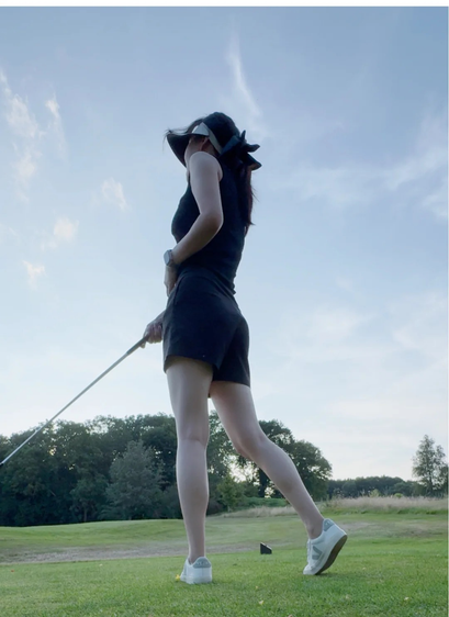 A beautiful Asian lady playing Golf.