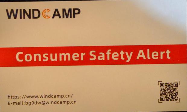 Small paper card saying "Consumer Safety Alert".