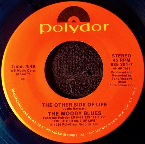 On blue vinyl this is the 45 RPM single release, "The Other Side of Life" by The Moody Blues from 1986 on Polydor Records.