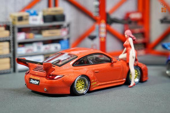 A right side of Old & New 997, Red metallic by Tarmac Works in 1:64 scale with 1:64 figures on AREA 164