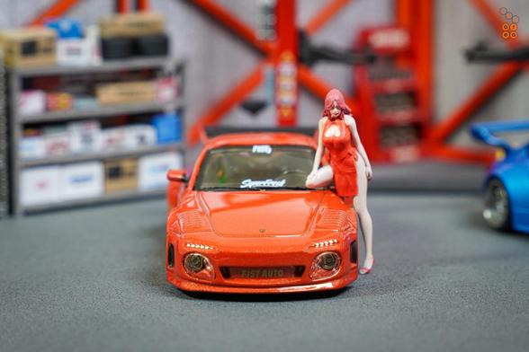 A front side of Old & New 997, Red metallic by Tarmac Works in 1:64 scale with 1:64 figures on AREA 164