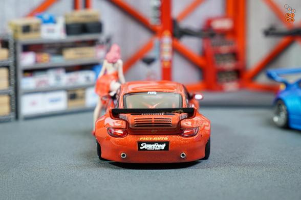 A rear side of Old & New 997, Red metallic by Tarmac Works in 1:64 scale with 1:64 figures on AREA 164