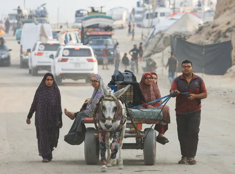 People flee on a donkey cart.