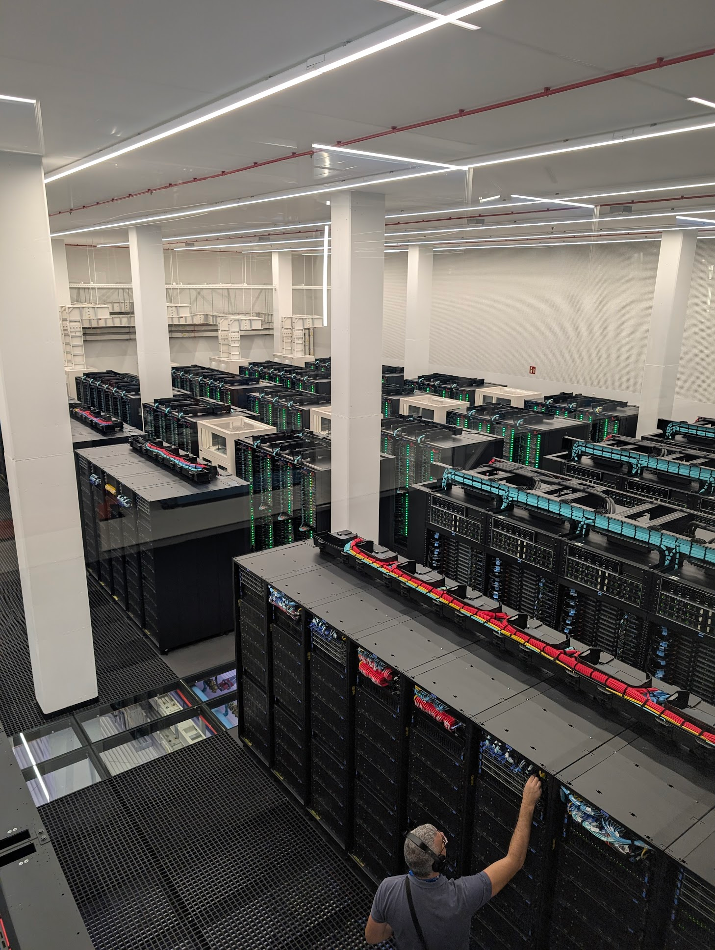 A server-room with lots of racks showing both CPU and GPU and lots of water cooling