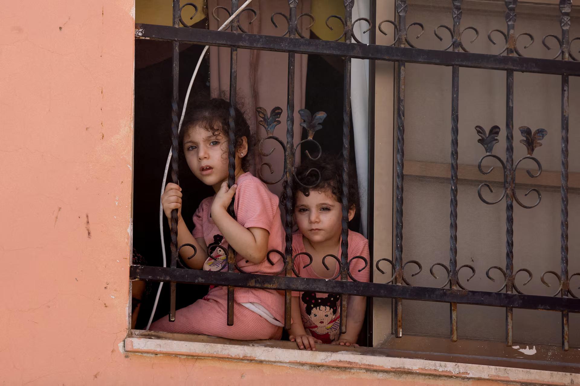 Children look out the window.