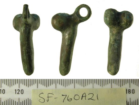 Roman phallic pendant from Suffolk, UK, 43-410 CE. The pendant has been photographed from all sides, a loop for a chain or necklace above the well-crafted scrotum. The tips of all three photos point downwards towards a measuring band.